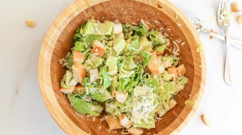 Caesar salad in wooden bowl