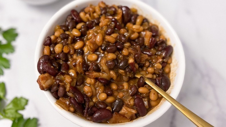 Baked beans on bowl with spoon