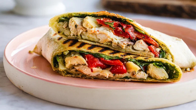 Antipasti Italian Chicken Wrap stacked on pink plate