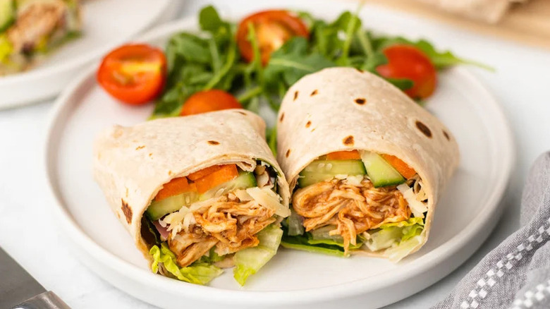 BBQ Chicken Lettuce Wraps with Crunchy Veggies on white plate with salad