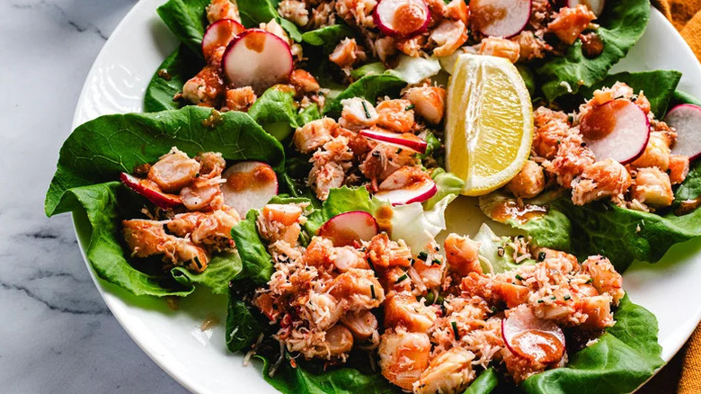 Crab and Shrimp Cocktail Lettuce Wraps on white plate with lemon