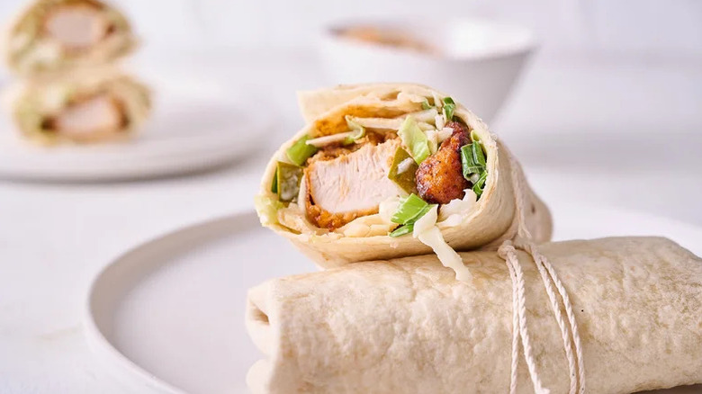 Nashville Hot Chicken Wraps with Pickle Slaw wrapped with twine on white plate