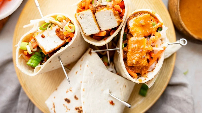 Thai-Inspired Crispy Tofu Wraps arranged on wooden board