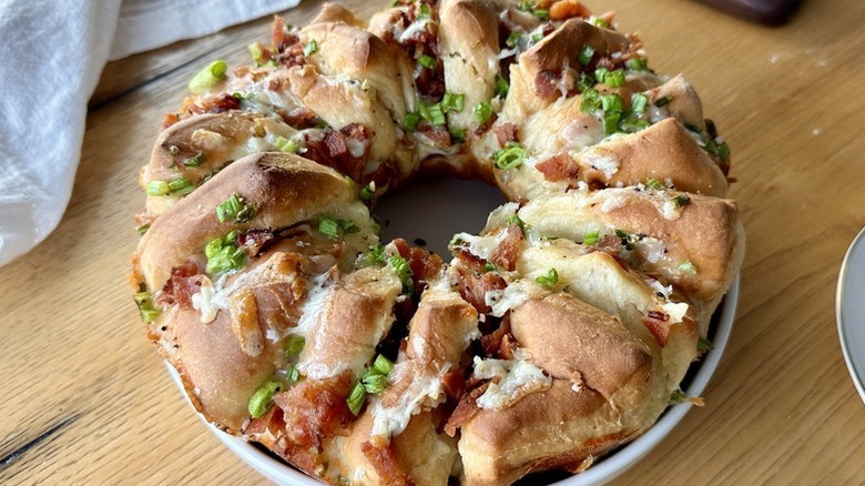 Wreath-shaped bacon cheddar bread topped with sliced green onions
