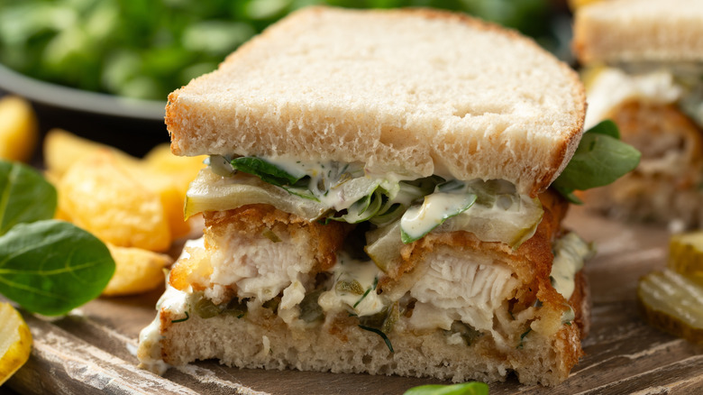 Fish Finger Sandwich cut in half on wooden board