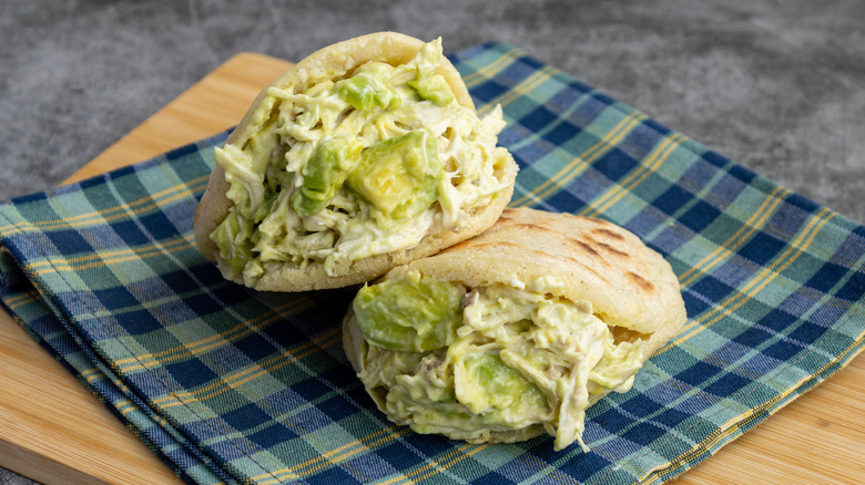 Arepas stuffed with creamy chicken on ceckered cloth