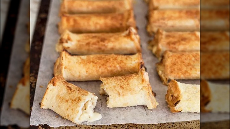 Cheese rolls on a piece of baking parchment