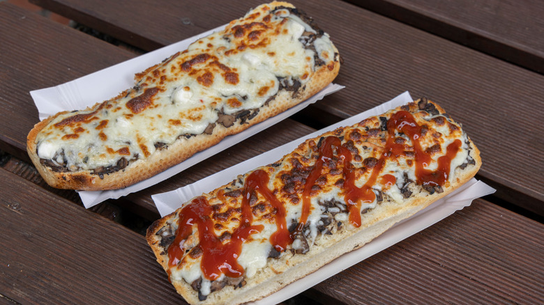 Two traditional Zapiekanka sandwiches on table