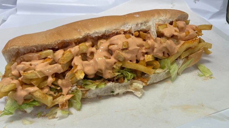 South African Gatsby sandwich with fries, lettuce, and sauce