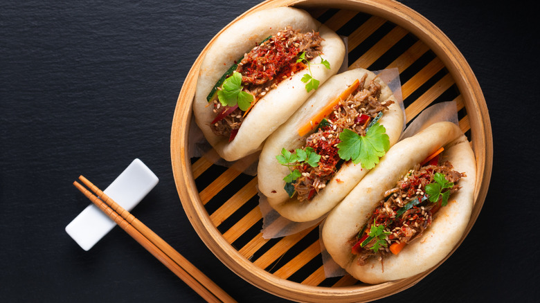 Gua bao with sandwich filling in wooden steamer
