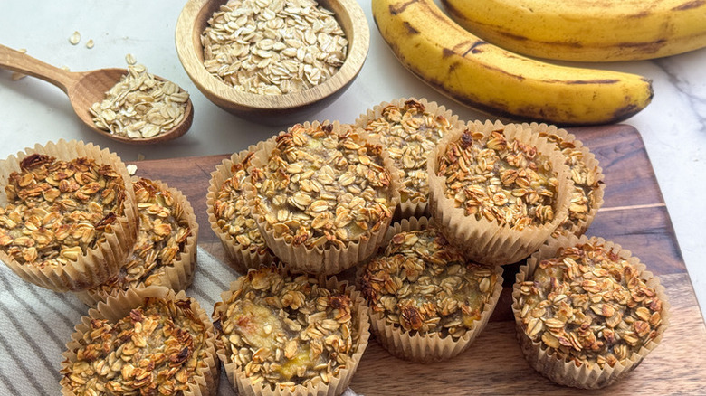Pile of banana oatmeal muffins on wooden board