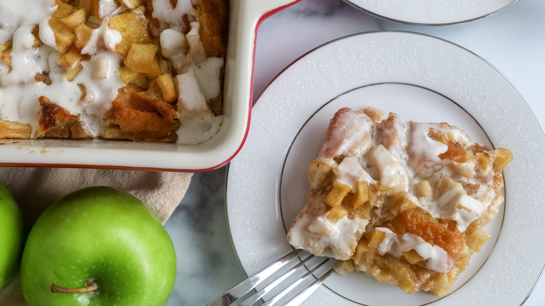Apple fritter breakfast casserole served from baking dish onto plate