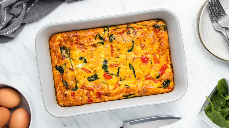 Bacon, egg, and spinach casserole in baking dish
