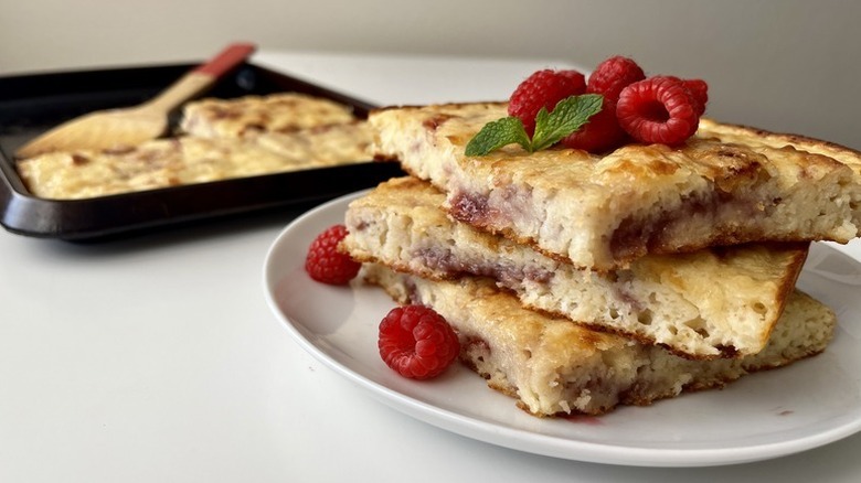 Stack of sheet pan raspberry pancakes on plate