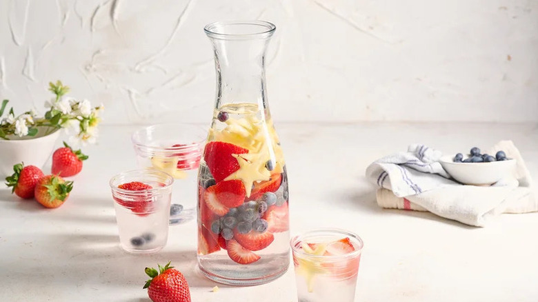 Festive Red, White, and Blue Infused Water in large pitcher on countertop