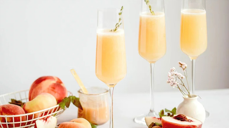 Fresh Peach Bellini Cocktails in three champagne glasses
