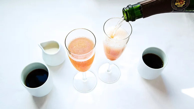 Wine being poured into champagne glass for Grilled Peach Mimosa
