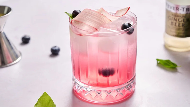 Rhubarb Blueberry Basil Mocktail in glass with rhubarb garnish