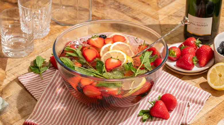 Summer Berry Champagne Punch Drink in punch bowl on striped towel