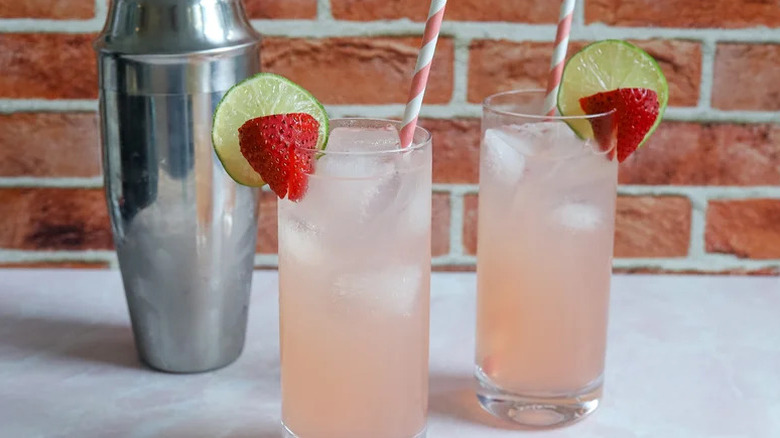 Summer Strawberry Paloma Cocktails in two Tom Collins glasses