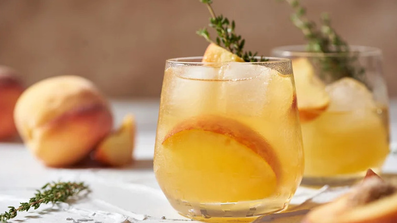 Summertime Peach Whiskey Smashes in stemless wine glasses