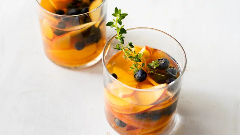 Sweet White Sangria in two tumblers on white surface