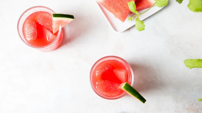 Watermelon Old Fashioned Drinks in two glasses with watermelon garnishes