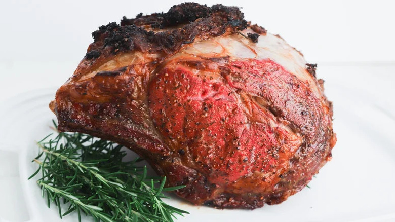 Slow-Roasted Rib Roast with rosemary on white plate