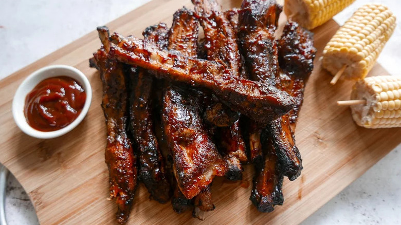 Tender Grilled Spare Ribs arranged on wooden cutting board