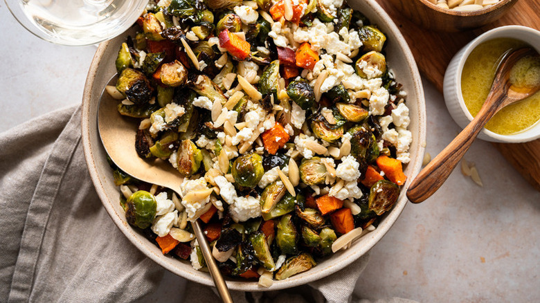 Roasted Brussels sprout, sweet potato, and feta salad in serving bowl
