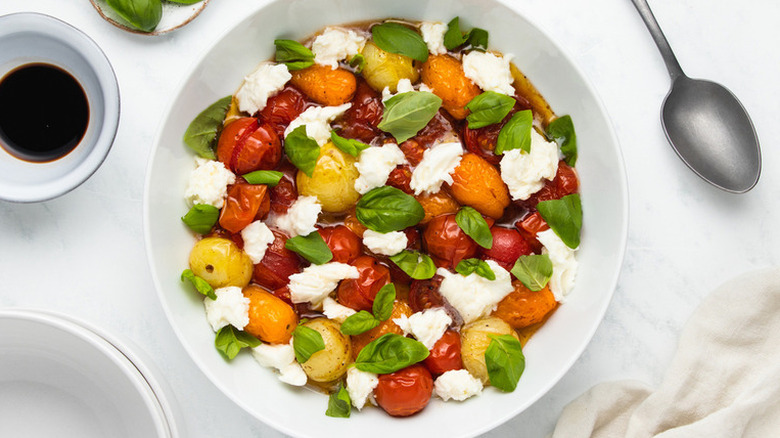 Roasted tomato Caprese salad in white bowl