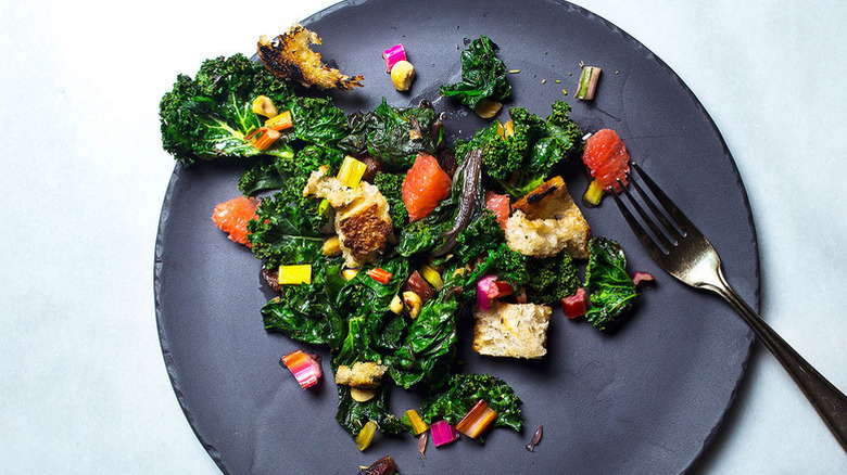 Rainbow chard salad on dark blue plate with fork