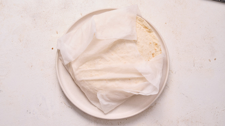 warming the tortillas on a plate