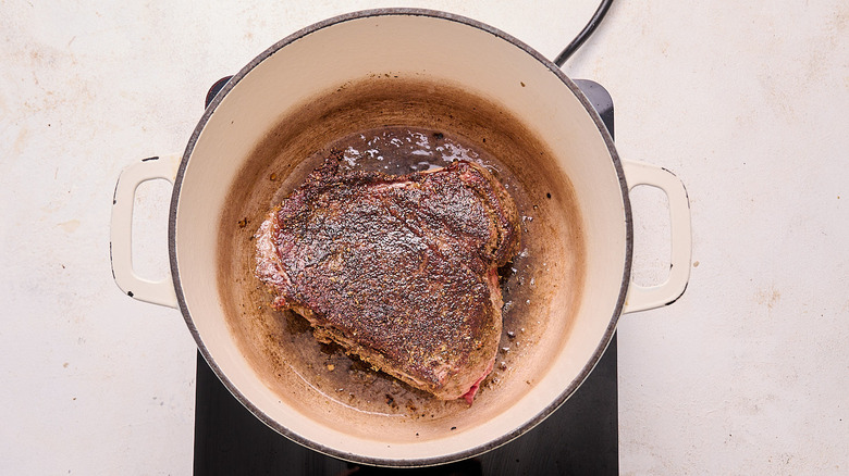 searing beef in a pot