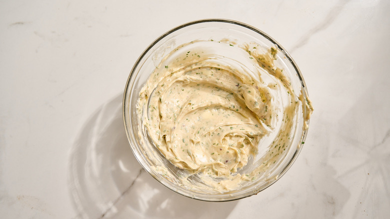 combining butter and anchovies in a bowl