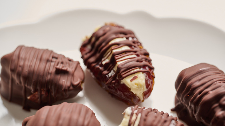 chocolate cheesecake covered dates on a plate