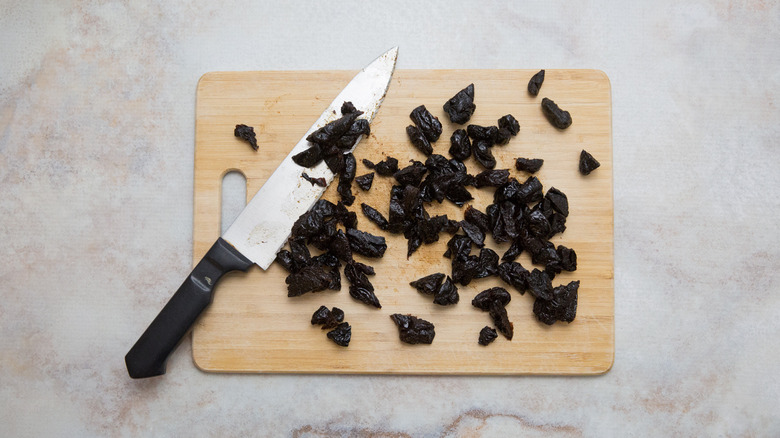 roughly chopped prunes on board