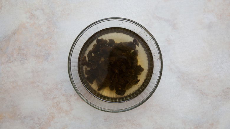 prunes soaking in glass bowl