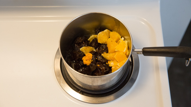 plum jam ingredients in pan