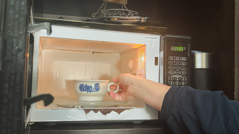 Placing a mug cake in a microwave