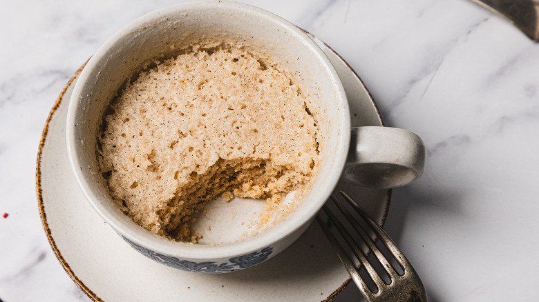 Vanilla mug cake with a piece taken out