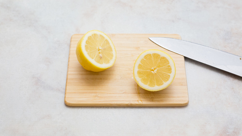 halved lemon on cutting board