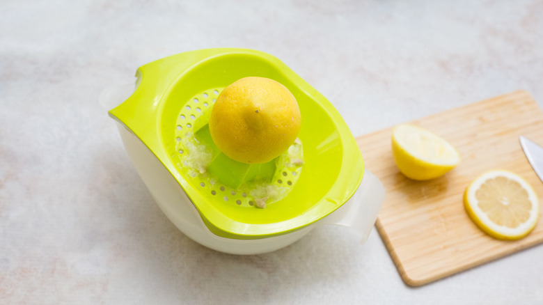 halved lemon on citrus press