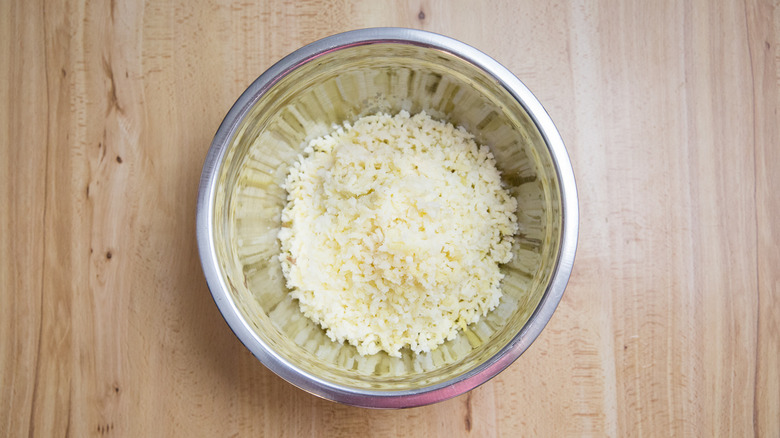 riced potatoes in mixing bowl