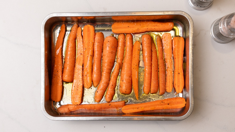 seasoned carrots in baking tray