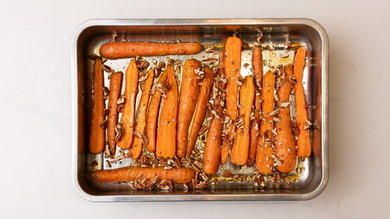 carrots and pecans in baking tray