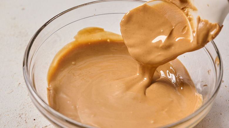 spatula stirring melted peanut butter