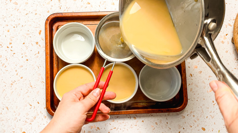 Straining panna cotta into ramekins