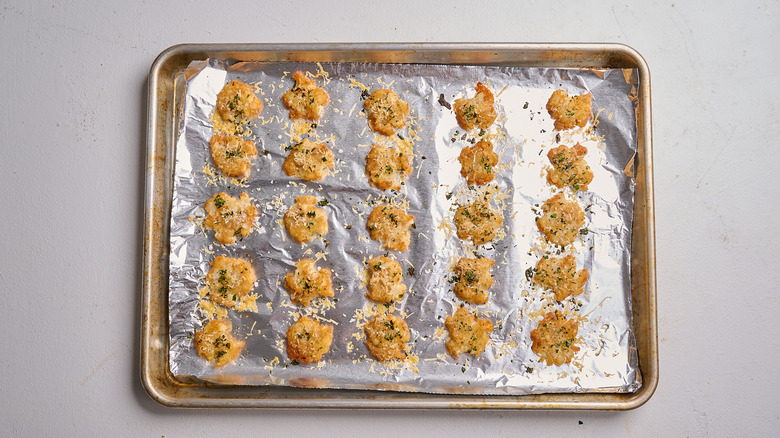baked smashed tater tots on a sheet tray