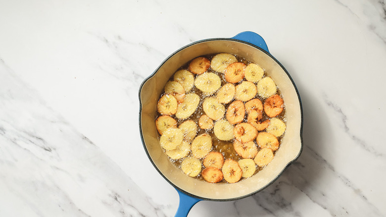 Frying plantain chips in oil